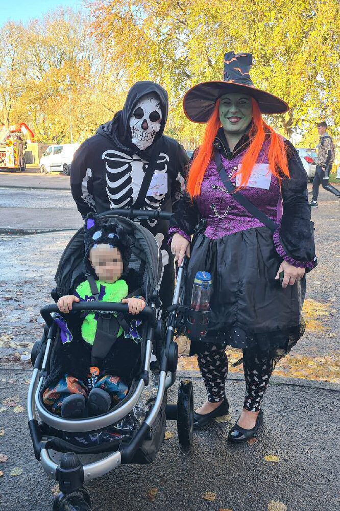 Photograph: Couple with child in Halloween costumes.